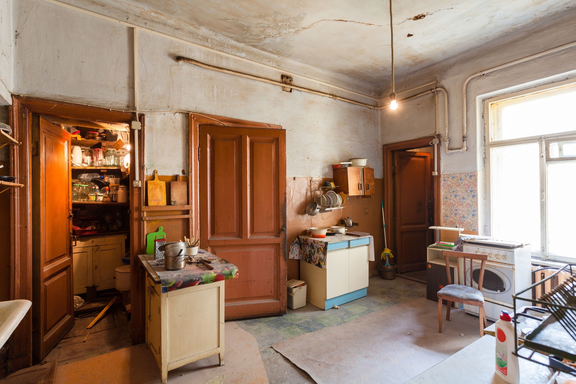 Dirty kitchen with furniture and gas stoves  is in the apartment for temporary  living (existence) refugees who were forced to migrate and emigrate from other countries.